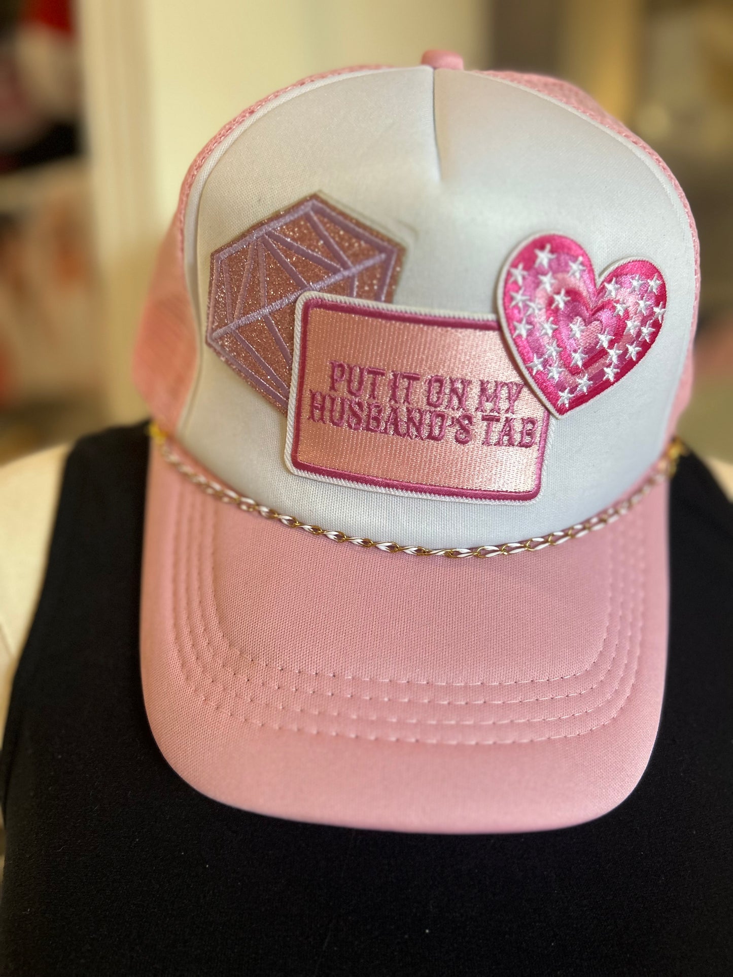 Pink put it on my Husband’s tab Trucker Hat